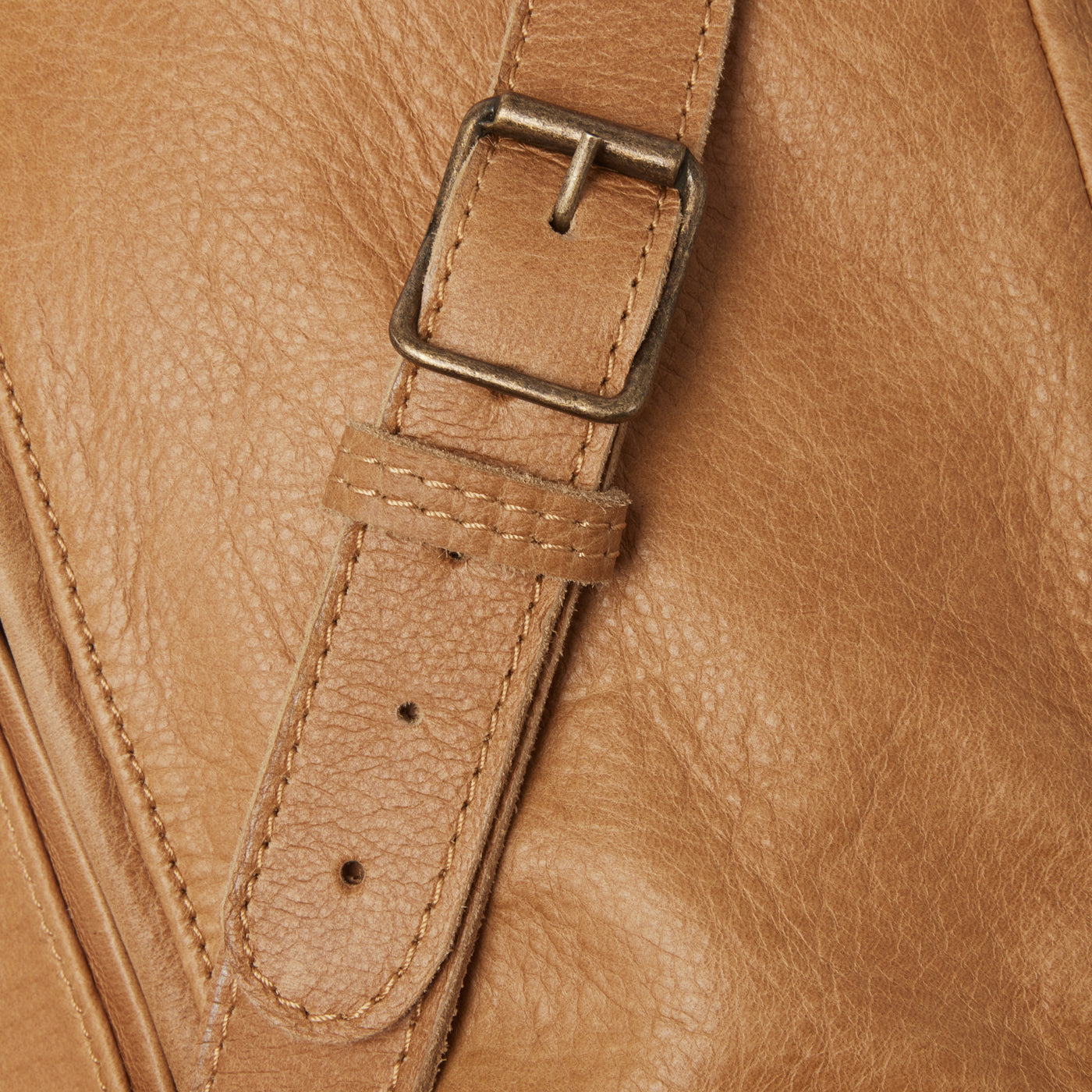 Hidden pocket. Buckled front. Italian hardware.