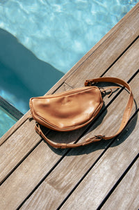 Tan leather Rowdy Moon Bag by the pool