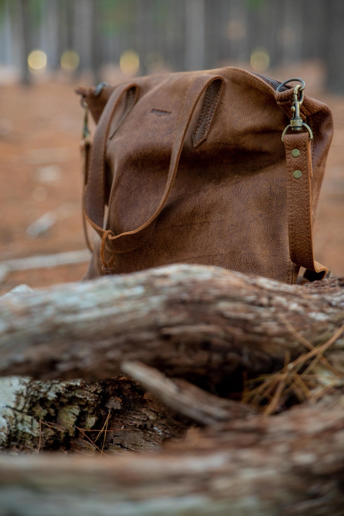 Tan Rowdy Tote Crossbody in the woods