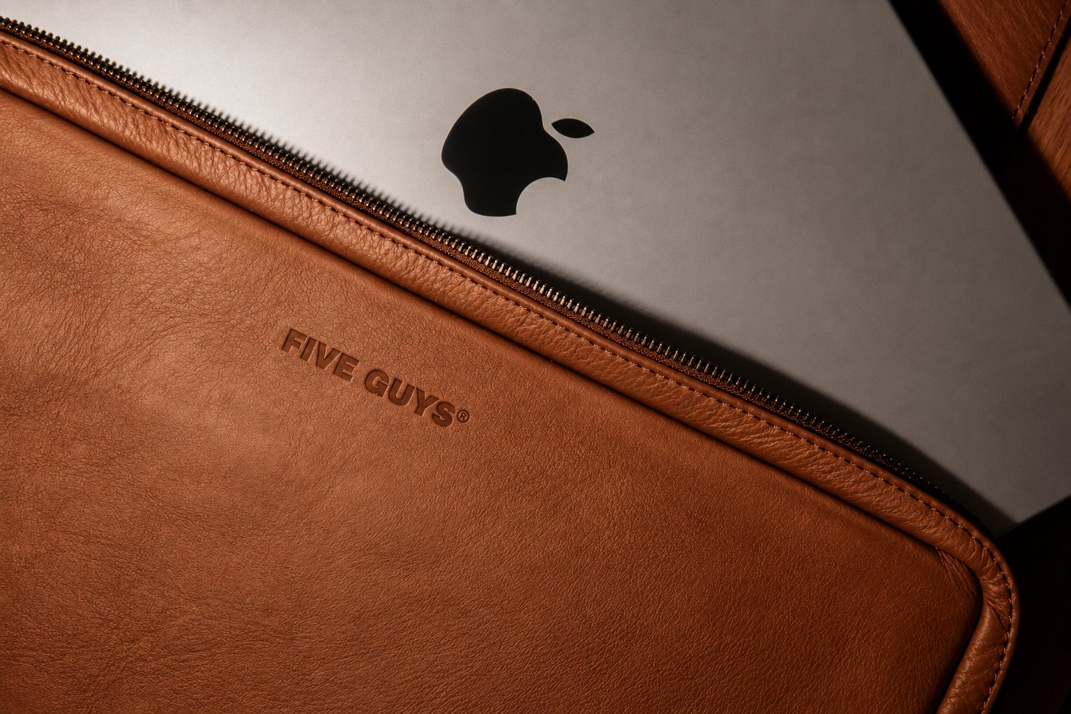 Five Guys branded leather laptop sleeve with stamped logo